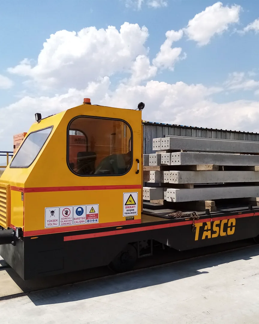 TASCO shunting locomotive with flat wagon loaded with concrete sleepers